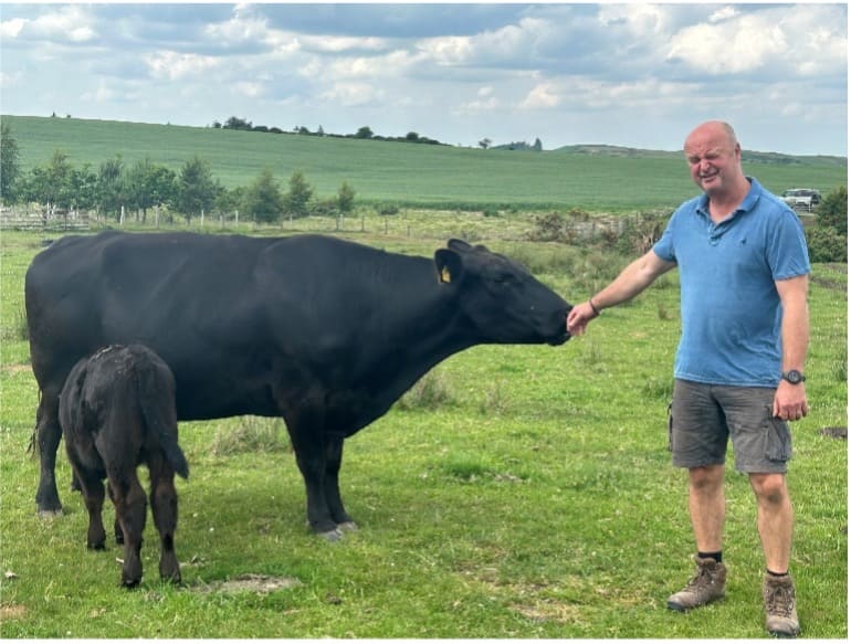 John Renner and an angus cow